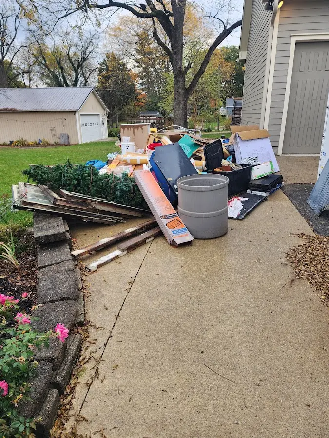 Dumpster being loaded with debris for 12 Yard Dumpster Rental in Templeton